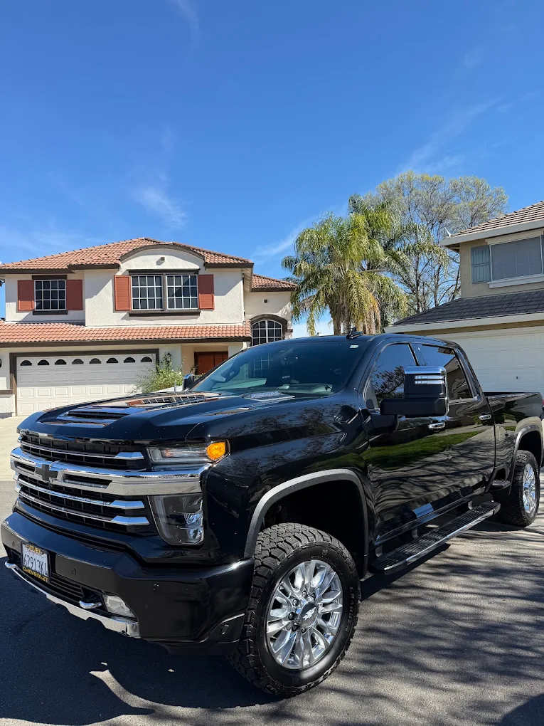Detailed black Chevy Silverado High Country in driveway